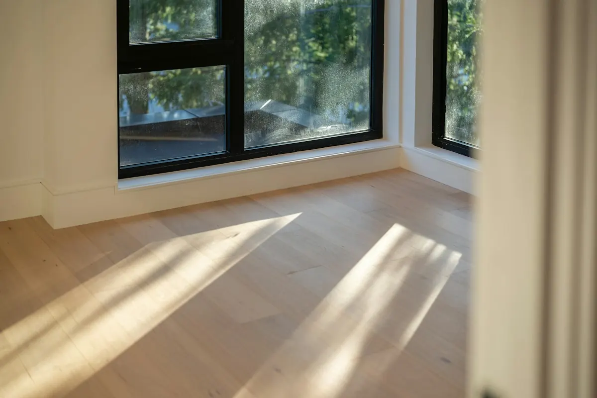Sunlit empty room with dry, finished wood flooring