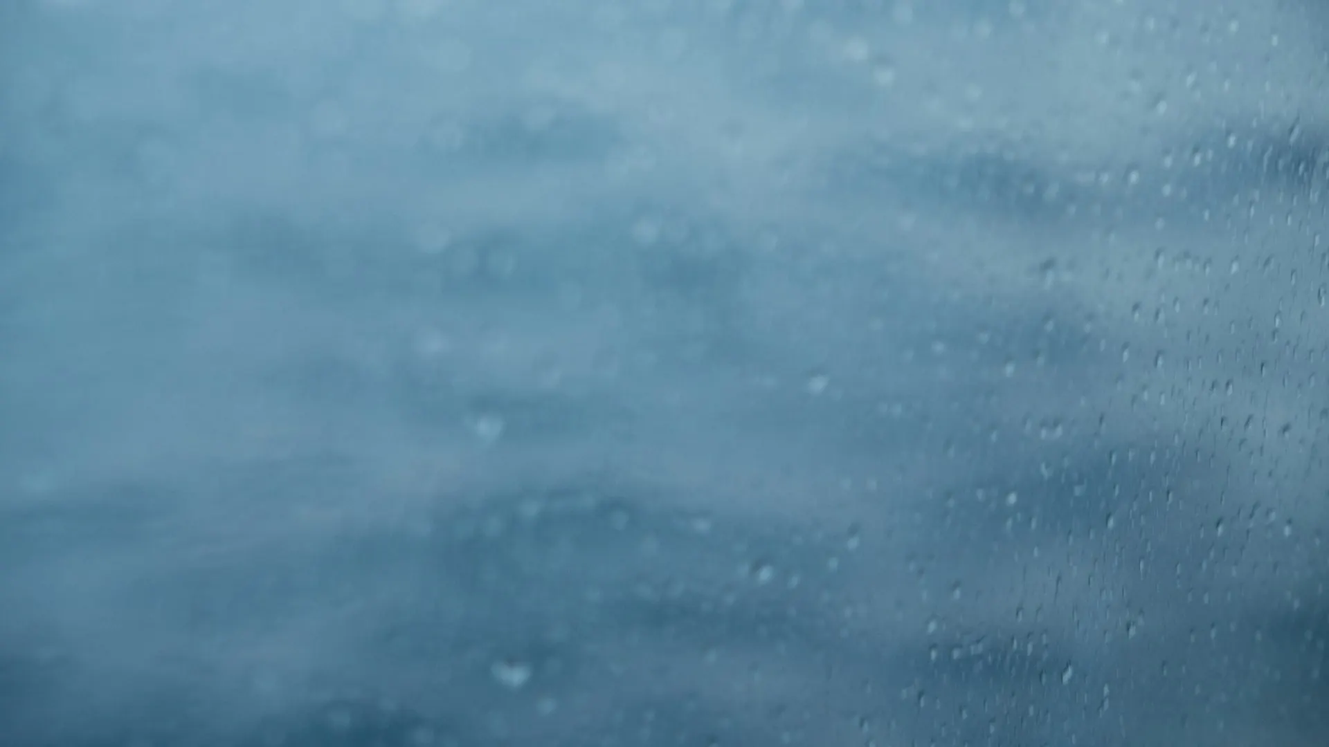 Raindrops on a window during a coastal storm